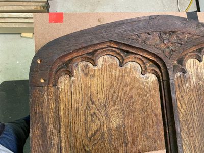 Gothic tracery detail on original carved oak door header — historic restoration Wyndmoor PA